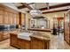 Gourmet kitchen features custom wood cabinets, granite countertops, island, and stainless steel appliances at 6305 E Arabian Way, Paradise Valley, AZ 85253