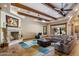 Open concept living room boasts a fireplace and expansive window views of the pool area at 6305 E Arabian Way, Paradise Valley, AZ 85253