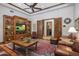 Spacious living room with wood-trimmed ceiling, built-in shelving, and comfortable leather seating at 6305 E Arabian Way, Paradise Valley, AZ 85253