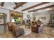Cozy living room with a stone fireplace, built-in media center, and exposed beam ceilings at 6305 E Arabian Way, Paradise Valley, AZ 85253