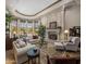 A bright living room features a stone fireplace, view of the outdoor pool, and sitting area with comfortable seating at 6305 E Arabian Way, Paradise Valley, AZ 85253