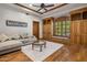 The living room has hardwood floors, wood trim, built-in shelving, and a comfortable couch at 6305 E Arabian Way, Paradise Valley, AZ 85253