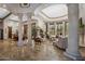 Spacious living room with travertine tile, large windows, and decorative columns creating an open and airy atmosphere at 6305 E Arabian Way, Paradise Valley, AZ 85253