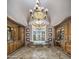 Luxurious bathroom featuring a jacuzzi tub with decorative tile work, chandelier and dual vanities at 6305 E Arabian Way, Paradise Valley, AZ 85253