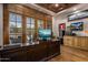 An office with hardwood floors, large windows, wooden trim, and custom built-in storage at 6305 E Arabian Way, Paradise Valley, AZ 85253