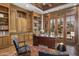 Well-appointed office with custom built-ins, hardwood floors, and French doors leading to outdoor pool at 6305 E Arabian Way, Paradise Valley, AZ 85253