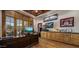 A handsome office featuring wood floors, built-in shelves, a large desk and natural light at 6305 E Arabian Way, Paradise Valley, AZ 85253