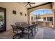 Covered patio with an outdoor dining table, ceiling fan, and a built-in grill at 6305 E Arabian Way, Paradise Valley, AZ 85253