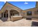 Outdoor kitchen with bar seating under a covered patio and travertine flooring at 6305 E Arabian Way, Paradise Valley, AZ 85253