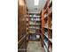Organized walk-in pantry with custom wooden shelving and ample storage space for food and household items at 6305 E Arabian Way, Paradise Valley, AZ 85253