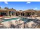 An inviting pool and spa combination surrounded by an elegant patio and beautiful architecture at 6305 E Arabian Way, Paradise Valley, AZ 85253