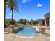Backyard pool with fountains, surrounded by lush landscaping and ample lounging space at 6305 E Arabian Way, Paradise Valley, AZ 85253