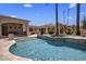 Inviting pool with travertine surround, palm trees, and adjacent structure under a sunny sky at 6305 E Arabian Way, Paradise Valley, AZ 85253