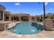 Sparkling backyard pool with fountains and lush landscaping, ideal for relaxation and entertainment at 6305 E Arabian Way, Paradise Valley, AZ 85253