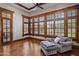 A sitting area with hardwood floors, large windows, wooden trim, and comfortable seating at 6305 E Arabian Way, Paradise Valley, AZ 85253