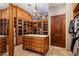 A walk-in closet with custom shelving, cabinets, and a central island with drawers at 6305 E Arabian Way, Paradise Valley, AZ 85253