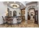 An entertaining wet bar area complete with seating, custom tilework, and built-in shelving at 6305 E Arabian Way, Paradise Valley, AZ 85253