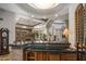 Elegant wet bar showcasing custom cabinetry, granite countertops, and seamless flow to dining and living areas at 6305 E Arabian Way, Paradise Valley, AZ 85253