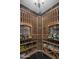 Well-stocked wine cellar with custom wood racking, and display shelves for an extensive wine collection at 6305 E Arabian Way, Paradise Valley, AZ 85253