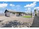 Gravel backyard features artificial grass section and covered patio, great for low-maintenance living at 6420 S Wilson St, Tempe, AZ 85283