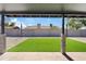 Cozy covered patio with artificial grass and cinder block fence, perfect for outdoor relaxation at 6420 S Wilson St, Tempe, AZ 85283