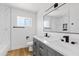 Bright bathroom features a double sink vanity, elegant fixtures, and stylish marble shower tiles at 6420 S Wilson St, Tempe, AZ 85283