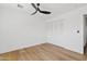 Well-lit bedroom featuring a ceiling fan and a closet with folding doors at 6420 S Wilson St, Tempe, AZ 85283