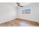 Bright bedroom with a ceiling fan and large window offering exterior views at 6420 S Wilson St, Tempe, AZ 85283