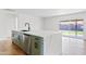 Elegant kitchen island with quartz countertops, a modern sink, and stylish cabinetry with stainless steel appliances at 6420 S Wilson St, Tempe, AZ 85283