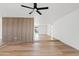 Open-concept living room boasts hardwood floors, an accent wall, and a modern ceiling fan for added comfort at 6420 S Wilson St, Tempe, AZ 85283