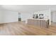 Open concept living space boasts hardwood floors and a connected kitchen with stainless steel appliances at 6420 S Wilson St, Tempe, AZ 85283