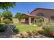 Spacious backyard includes grassy area, covered patio and well-manicured landscaping at 6758 W Quail Ave, Glendale, AZ 85308