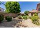 Backyard space with gravel, grass and plenty of vegetation at 6758 W Quail Ave, Glendale, AZ 85308