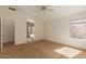 Bright bedroom with a ceiling fan, neutral carpet, and natural light coming through the window at 6758 W Quail Ave, Glendale, AZ 85308