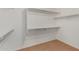 Spacious walk-in closet with built-in shelving and carpeted flooring, ready for organization at 6758 W Quail Ave, Glendale, AZ 85308
