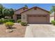 Exterior of single story home, showing two car garage and desert landscaping at 6758 W Quail Ave, Glendale, AZ 85308