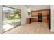 Bright kitchen with wood cabinets, black appliances, and a sliding glass door leading to the backyard at 6758 W Quail Ave, Glendale, AZ 85308
