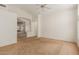 Spacious living room with a neutral carpet, fan and an open archway leading to another area at 6758 W Quail Ave, Glendale, AZ 85308