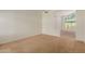 Spacious living room with neutral carpet, arched doorways, and abundant natural light at 6758 W Quail Ave, Glendale, AZ 85308