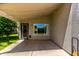 Covered patio offers shade, complemented by well-kept backyard and tasteful exterior lighting at 723 N Joshua Tree Ln, Gilbert, AZ 85234