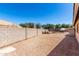 Enclosed backyard featuring desert landscaping, a pool, and mature greenery for privacy at 723 N Joshua Tree Ln, Gilbert, AZ 85234