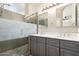 Bathroom with a double vanity, stone countertops, and a large glass enclosed walk-in shower at 723 N Joshua Tree Ln, Gilbert, AZ 85234