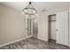 Bedroom with modern lighting, neutral paint, vinyl floors, closet, and a french door at 723 N Joshua Tree Ln, Gilbert, AZ 85234