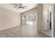 This bedroom features tile flooring, a ceiling fan, access to the backyard, and an ensuite bathroom at 723 N Joshua Tree Ln, Gilbert, AZ 85234
