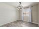 Cozy dining room featuring a modern lighting fixture, wood-style flooring, and shiplap accent wall at 723 N Joshua Tree Ln, Gilbert, AZ 85234