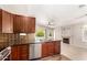 Modern kitchen featuring stainless appliances, hardwood cabinets, and views to the living room at 723 N Joshua Tree Ln, Gilbert, AZ 85234
