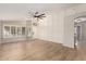 Bright and spacious living room with wood floors, large ceiling fan and an elegant front entry at 723 N Joshua Tree Ln, Gilbert, AZ 85234