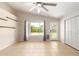 Bright sunroom with tile floor, fan, back yard access and a large window for ample natural light at 723 N Joshua Tree Ln, Gilbert, AZ 85234
