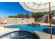 Private pool with a rock waterfall, a hot tub, and a serene backyard setting at 723 N Joshua Tree Ln, Gilbert, AZ 85234