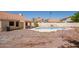 A backyard featuring a pool and plenty of space ready for personalization and landscaping at 7603 W Oraibi Dr, Glendale, AZ 85308